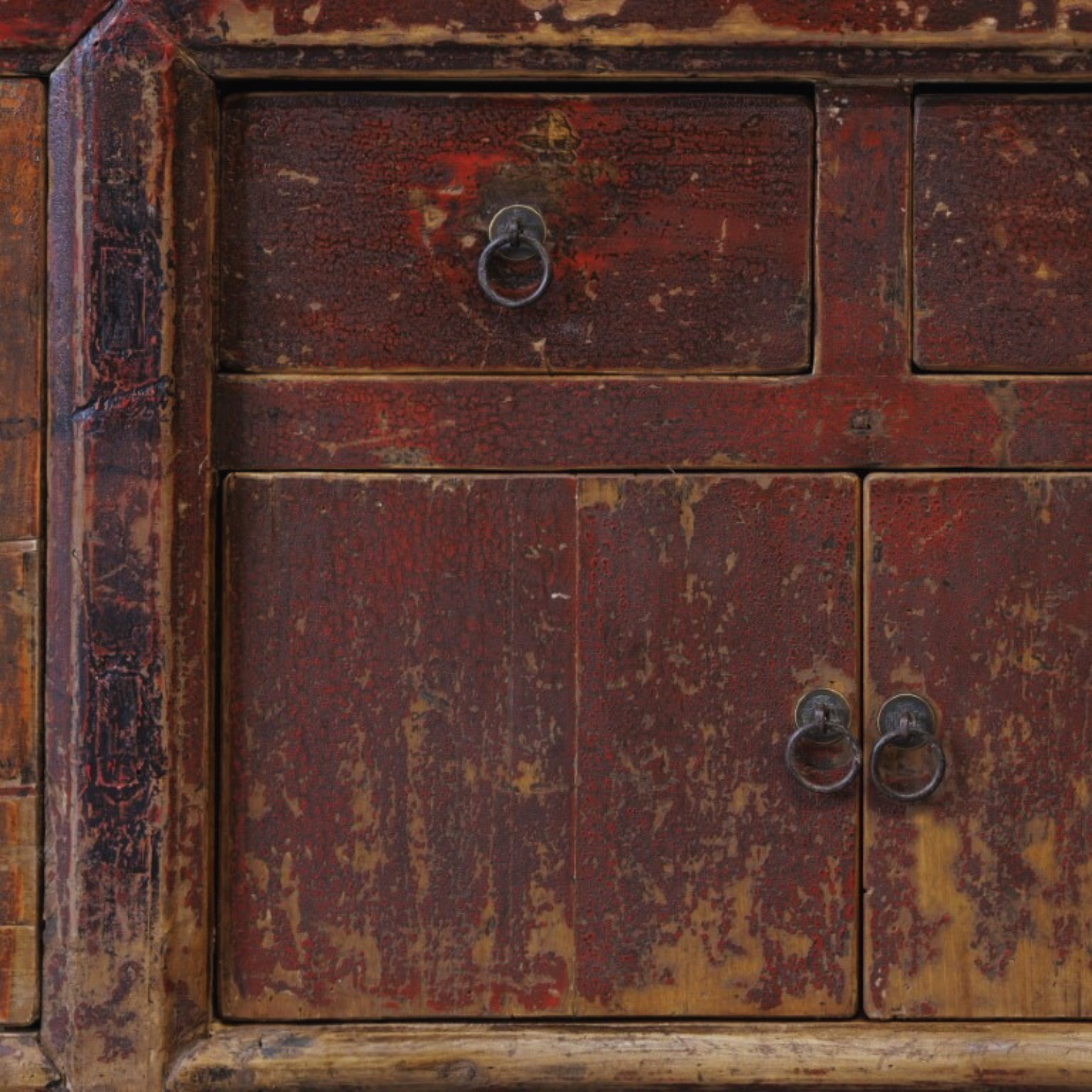 Close-up of an old, weathered wooden cabinet with peeling paint.