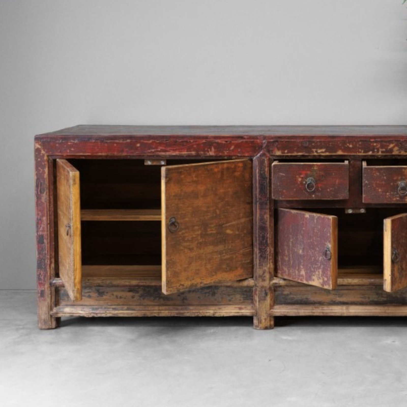 Vintage wooden sideboard with distressed finish on a gray background