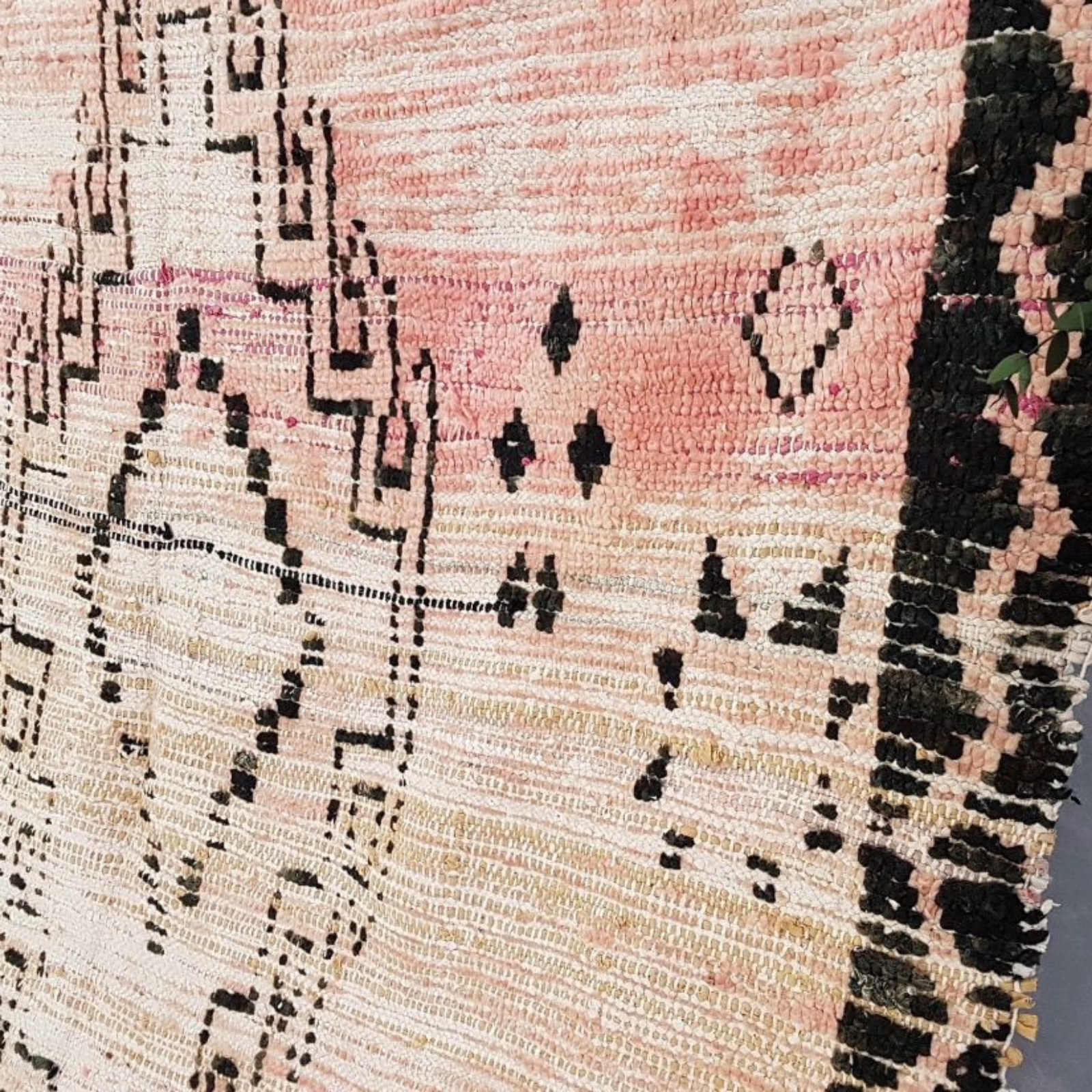 Close-up of a textured fabric with black and pink patterns